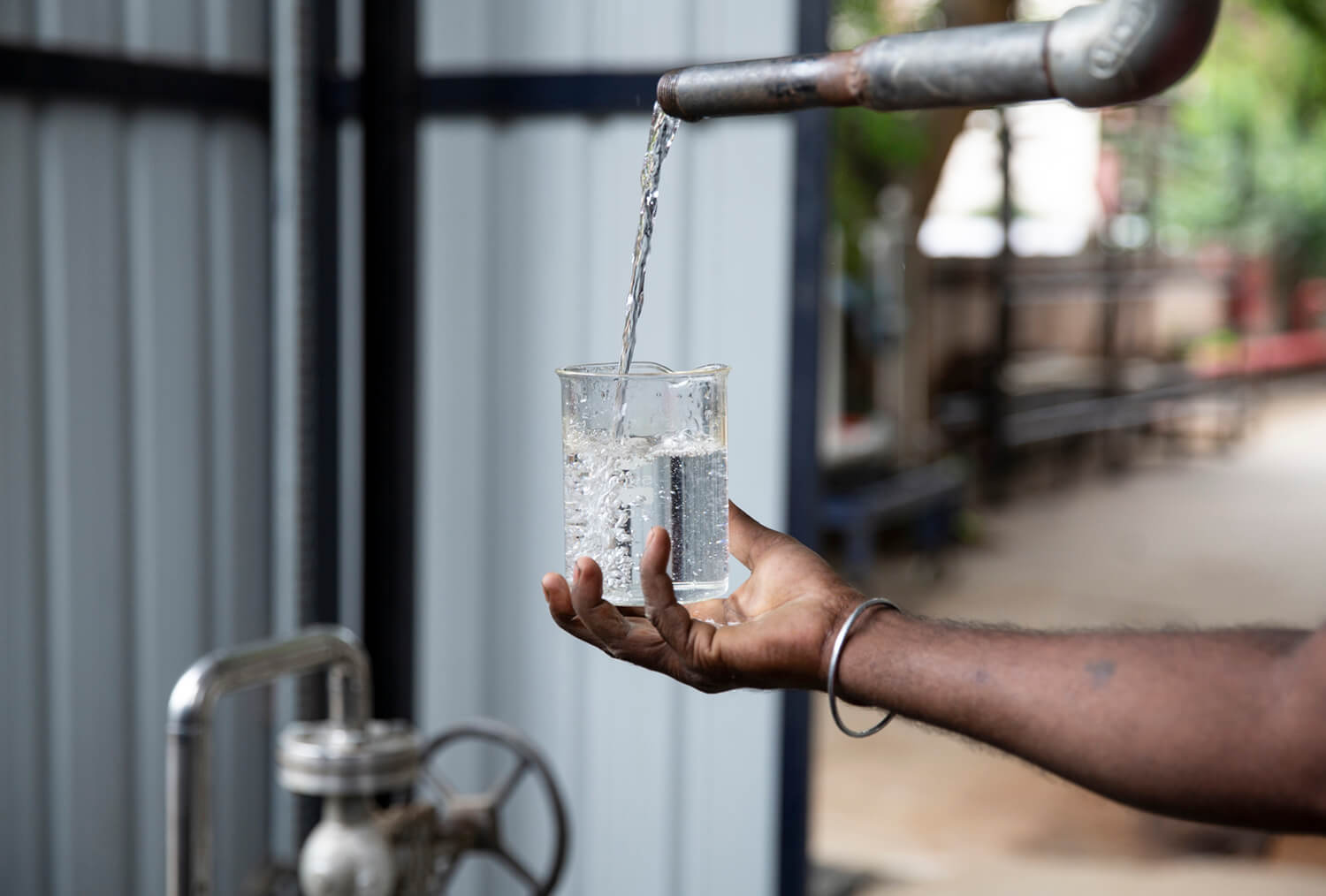 Hand holding glass of water