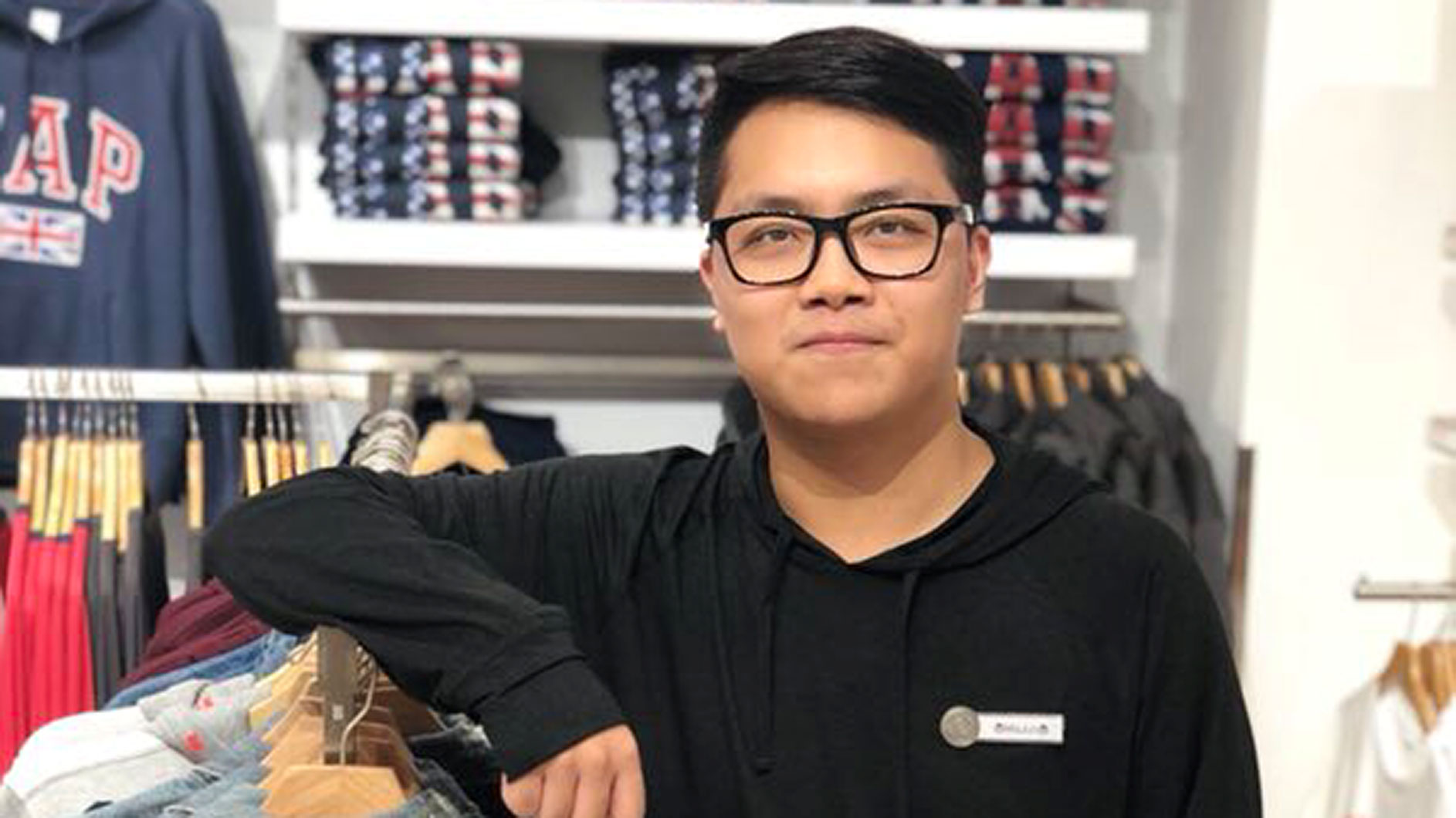 Major Smiling Near Clothes Rack