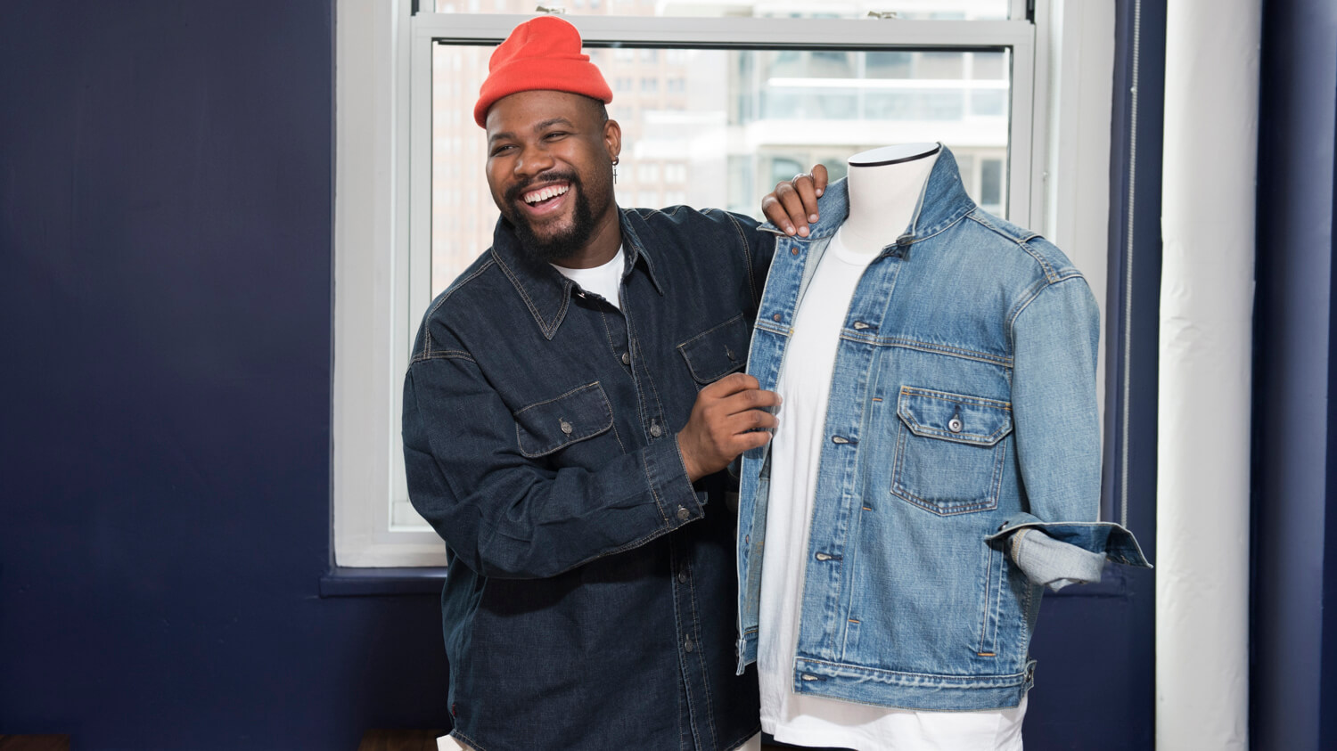 Employee adjusting denim jacket